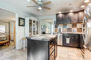 a kitchen with a ceiling fan and a kitchen island at Englewood Bungalow 1 Mi to Beach Pets Welcome! in Englewood