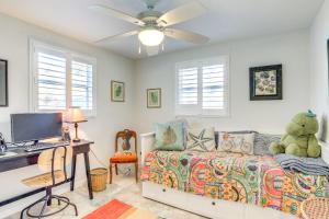 a bedroom with a bed and a desk with a computer at Englewood Bungalow 1 Mi to Beach Pets Welcome! in Englewood