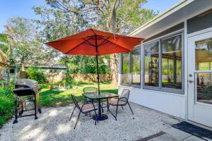 a table and chairs with an umbrella on a patio at Englewood Bungalow 1 Mi to Beach Pets Welcome! in Englewood