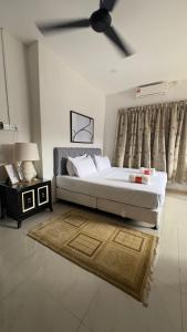 a bedroom with a large bed and a ceiling fan at Villa Alyana in Ipoh