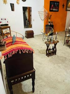a bedroom with a bed and tables in a room at Surf Casita Mexicana Next to Playa San Diego in Santiago Astata