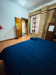 a bedroom with a large blue bed in a room at Surf Casita Mexicana Next to Playa San Diego in Santiago Astata