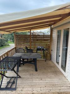 a patio with a table and chairs on a deck at Neptune 158 Argeles in Argelès-sur-Mer