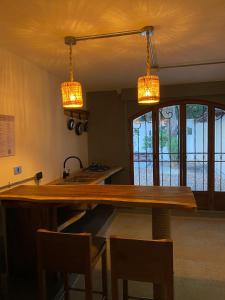 a kitchen with a wooden counter and two lights at Casa Piedra Barranquilla in Barranquilla