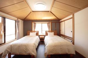 Postel nebo postele na pokoji v ubytování Izumigo AMBIENT Yatsugatake Cottage