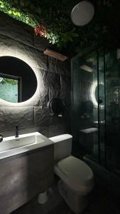 a bathroom with a toilet and a sink and a mirror at The Secret Garden Hostel in Lima +35 photos