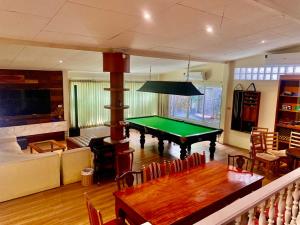 a living room with a pool table in it at Country Lake View Hotel in Suphan Buri