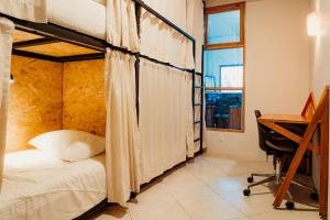Voodi või voodid majutusasutuse Kualena Hostal toas