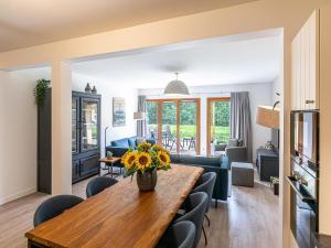 a living room with a table with flowers on it at Sunny Terrace & Ski Access in Abondance