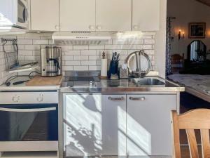 a kitchen with a sink and a stove at 3 person holiday home in ÖDSMÅL in Ödsmål +14 photos