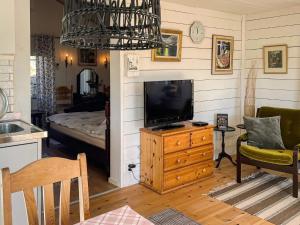 a living room with a television on a wooden dresser at 3 person holiday home in ÖDSMÅL in Ödsmål