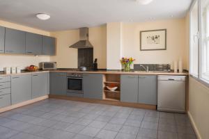 a kitchen with a stove a sink and a refrigerator at Princes Street Suites in Edinburgh