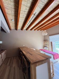 a kitchen with a wooden table in a room at Moderna Cabaña en Purmamarca in Purmamarca +2 photos