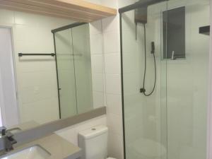a bathroom with a shower and a toilet and a sink at Apartamento SOHO - perto da WEG in Jaraguá do Sul +12 photos