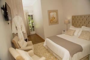 a bedroom with a bed and a couch and a chair at Barney Barnato in Kimberley +60 photos