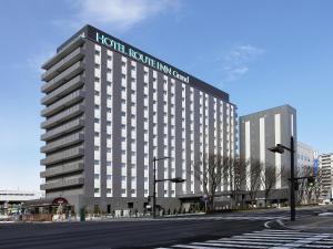 een weergave van een hotelgebouw aan een stadsstraat bij Hotel Route Inn Grand Fukushima Ekimae Higashiguchi in Fukushima