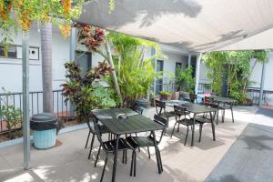 a group of tables and chairs on a patio at River of Gold Motel in Cooktown