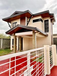 a house with a white fence in front of it at Downtown Chalet in Davao City