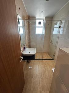 a bathroom with a sink and a shower at Poonam apartments 2 in Prayagraj