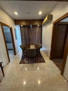 a dining room with a table and chairs in a room at Poonam apartments 2 in Prayagraj +1 photo