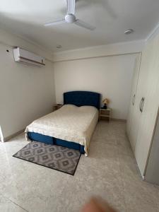a bedroom with a bed and a ceiling fan at Poonam apartments 2 in Prayagraj