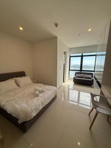 a bedroom with a bed and a chair in it at The Shore by New Voyage in Kota Kinabalu