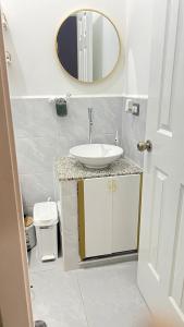 a bathroom with a sink and a mirror at Peace and Harmony welcome you! in San Miguel