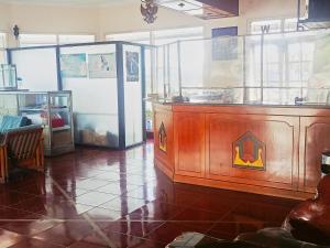 a room with a wooden counter with a large aquarium at Hotel Wijaya Purwokerto in Purwokerto