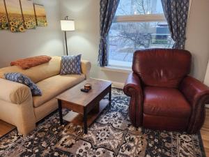 a living room with a couch and a chair and a table at Spacious 2BR Apt Downtown, 2 Blocks from State Capitol in Topeka