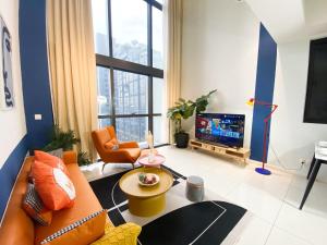 a living room with a couch and a tv at The Nordic - Icon City Petaling Jaya in Petaling Jaya