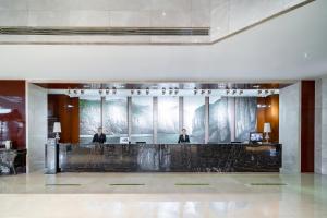 two men in the lobby of a hotel at Crowne Plaza Zhenjiang by IHG in Zhenjiang +132 photos
