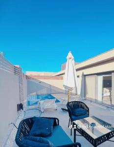 a balcony with two chairs and an umbrella at Bali A 22 in Hurghada