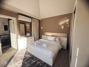 a bedroom with a white bed and a mirror at Bali A 22 in Hurghada