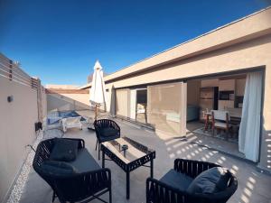 a patio with chairs and a table on a balcony at Bali A 22 in Hurghada