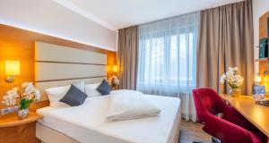 Postel nebo postele na pokoji v ubytování PLAZA INN Braunschweig City Süd