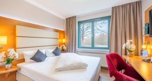 Postel nebo postele na pokoji v ubytování PLAZA INN Braunschweig City Süd