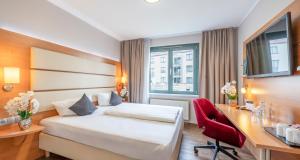 Postel nebo postele na pokoji v ubytování PLAZA INN Braunschweig City Süd