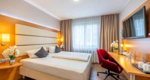 Postel nebo postele na pokoji v ubytování PLAZA INN Braunschweig City Süd