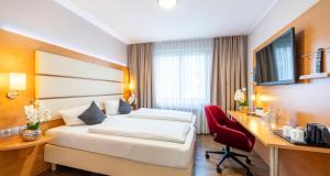 Postel nebo postele na pokoji v ubytování PLAZA INN Braunschweig City Süd