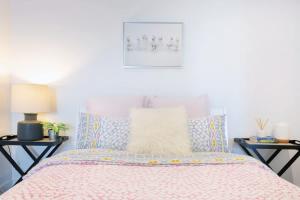 a bedroom with a bed with two night stands at Le Oasis Apt inCBD 2BR 3Beds near Southern cross in Melbourne