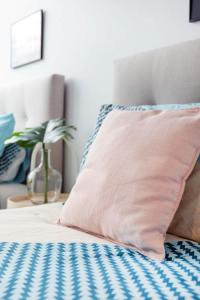 a pink pillow sitting on top of a bed at Le Oasis Apt inCBD 2BR 3Beds near Southern cross in Melbourne +31 photos