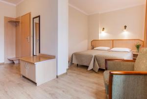 a hotel room with two beds and a table at Antica Residence in Krakow