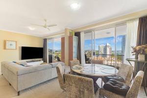 a living room with a couch and a table at Ocean Tower Unit 1104 - Twin Towns in Tweed Heads