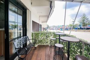 a balcony with tables and chairs on a building at Urbanview near Mall Botania 2 in Pulau Sembakau Besar