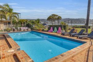 a swimming pool with blue water in a house at Lakeside Apartments - Fishpen in Merimbula