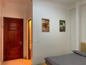 a bedroom with a door and two pictures on the wall at Home 33 in Sa Pa