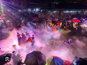 a group of people on a street with colored smoke at Home 33 in Sa Pa