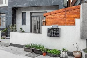 a house with a sign on the side of it at 西里海岸 電梯民宿 in Magong