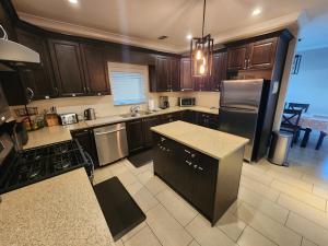a kitchen with wooden cabinets and a counter top at Burnaby 4 bed 3 bath duplex in Burnaby +14 photos