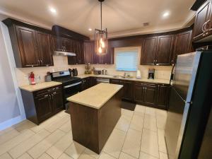 a kitchen with wooden cabinets and a counter top at Burnaby 4 bed 3 bath duplex in Burnaby